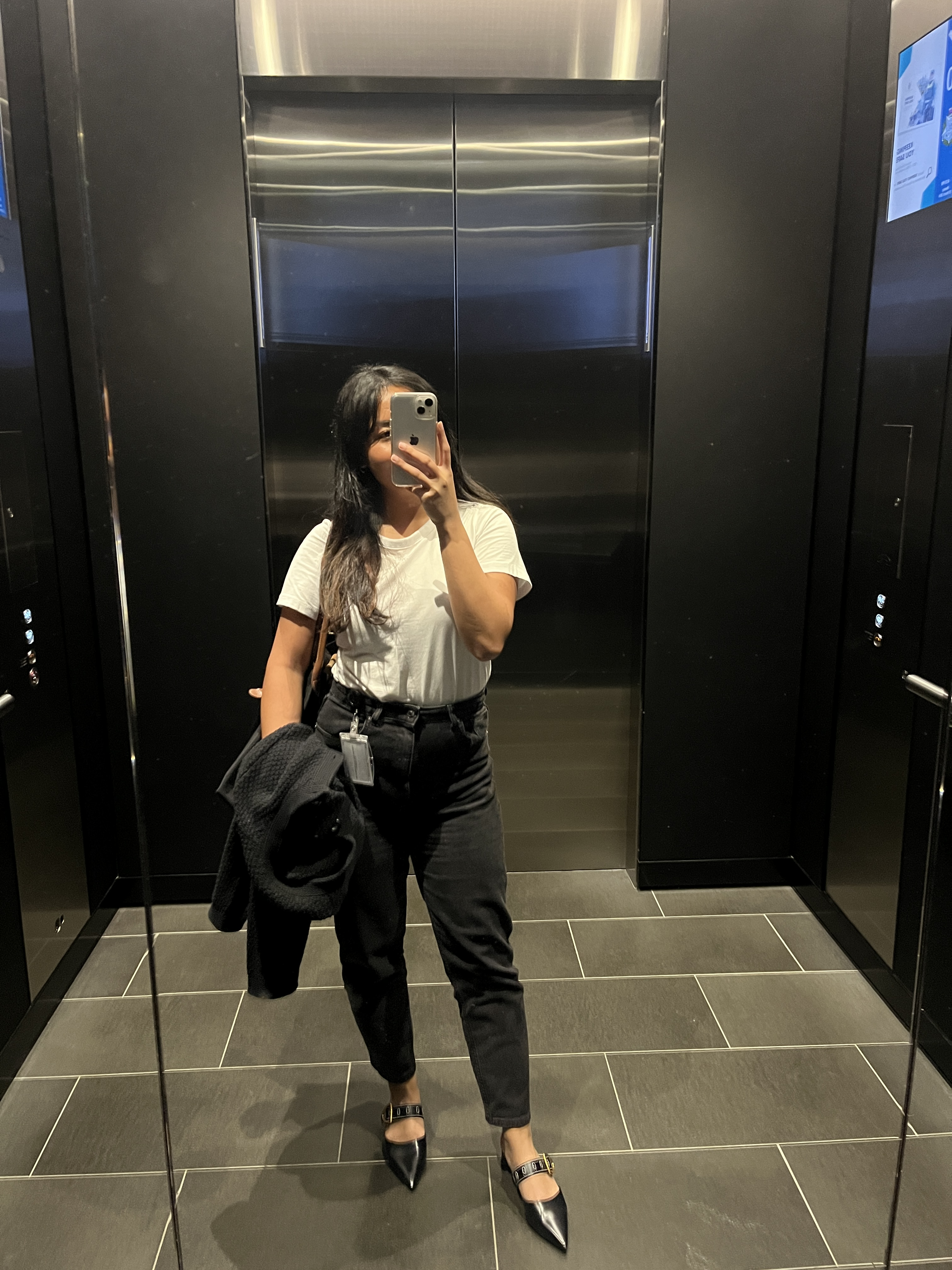 A photo of me taking a mirror selfie in the work elevator.